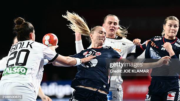 Germany's left back Emily Boelk tries to block Norway's centre back Henny Ella Reistad vie for the ball during the European Women's EHF EURO 2024...