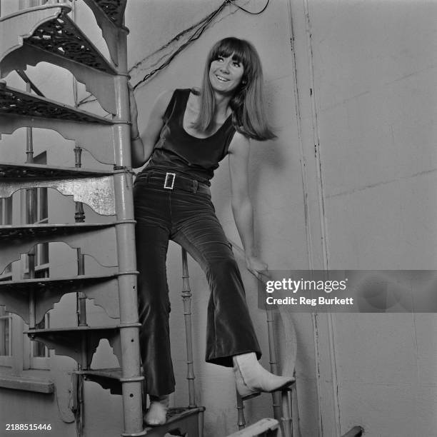 Singer Clodagh Rodgers poses on a spiral staircase, September 28th 1966.