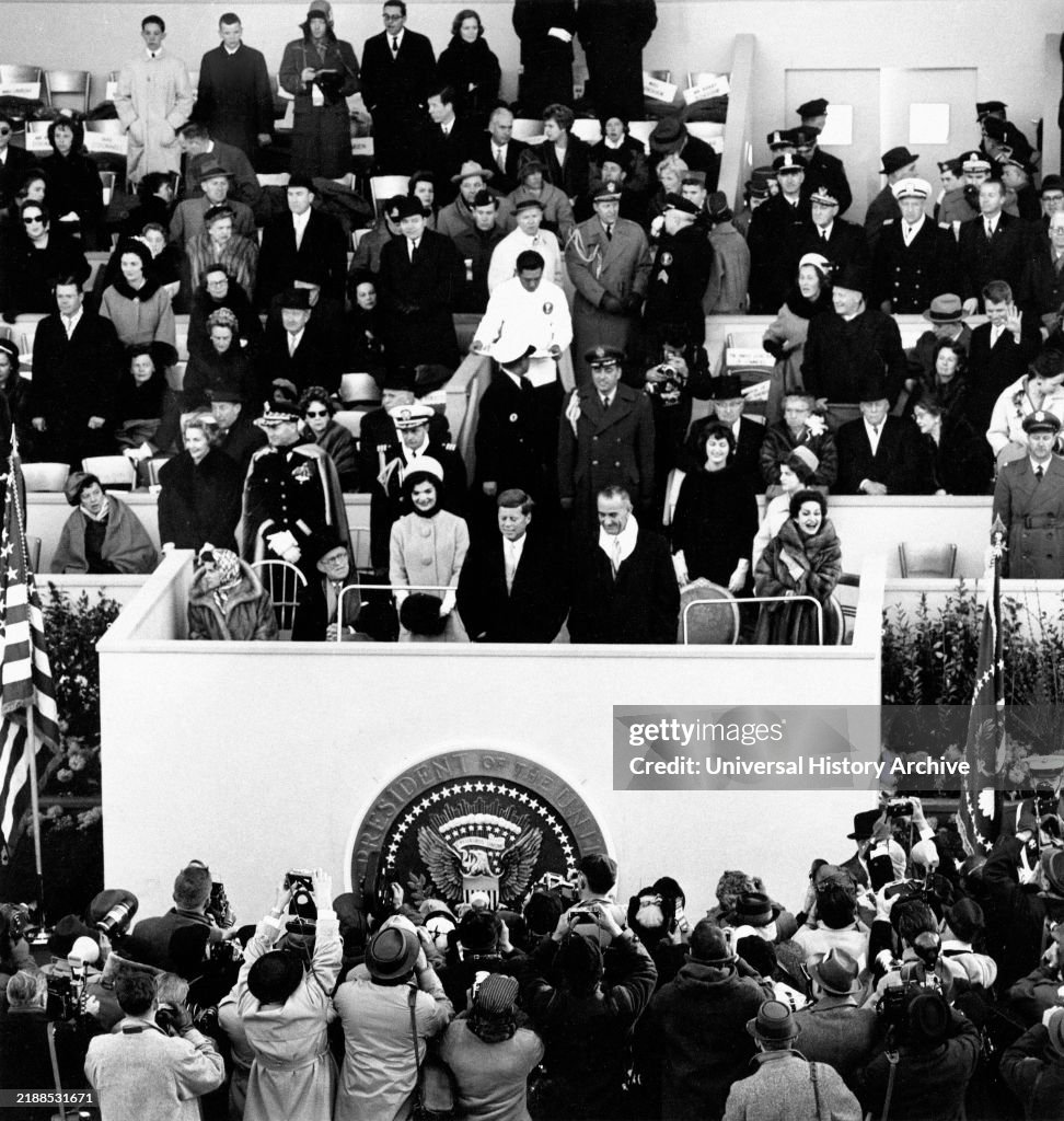 Joseph Kennedy, Rose Kennedy, Jacqueline Kennedy, U.S. President John Kennedy, U.S. Vice President Lyndon Johnson, Lady Bird Johnson and others on reviewing stand during inaugural parade, Pennsylvania Avenue, Washington, D.C., USA, Abbie Rowe, White House