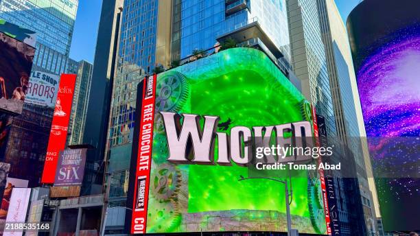 times square's digital screens and billboards advertisements in new york city - musical theater stock pictures, royalty-free photos & images