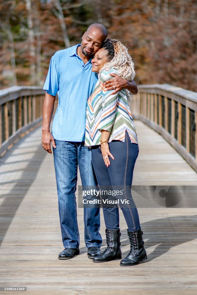 Couple hugging on bridge