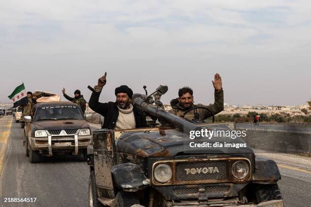 National Syrian Army soldiers celebrate in the city after opposition forces led by HTS took control of Hama city center and surrounding villages on...
