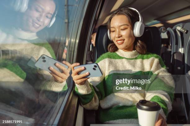 young woman using video streaming service on smartphone - streaming service stock pictures, royalty-free photos & images