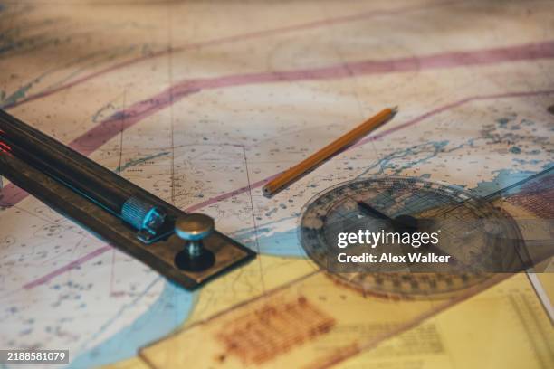 nautical chart with navigational tools on ships bridge. - rules stock pictures, royalty-free photos & images