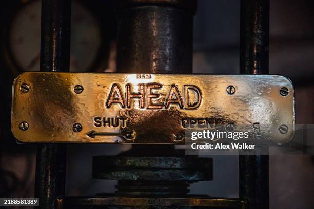brass plaque with ahead written in a ships engine room. - ahead only sign stock pictures, royalty-free photos & images