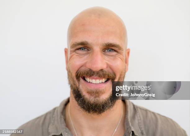 close-up of cheerful bearded man in early 40s - completely bald stock pictures, royalty-free photos & images