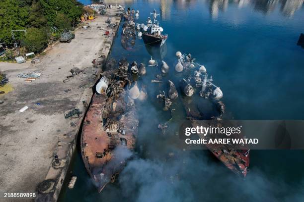 An aerial photo shows Syrian naval ships destroyed during an overnight Israeli attack on the port city of Latakia on December 10, 2024. The UN...