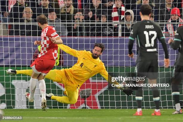 Girona's Dutch defender Daley Blind's shot is stopped by Liverpool's Brazilian goalkeeper Alisson Becker during the UEFA Champions League, league...