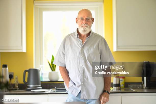 elderly man in his kitchen - senior men stock pictures, royalty-free photos & images