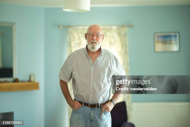 elderly man in his living room - bald man glasses beard stock pictures, royalty-free photos & images