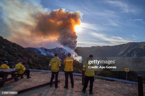 Firefighters monitor a mountainside burns as the Franklin Fire grows on December 10, 2024 near Malibu, California. The wildfire has scorched over...