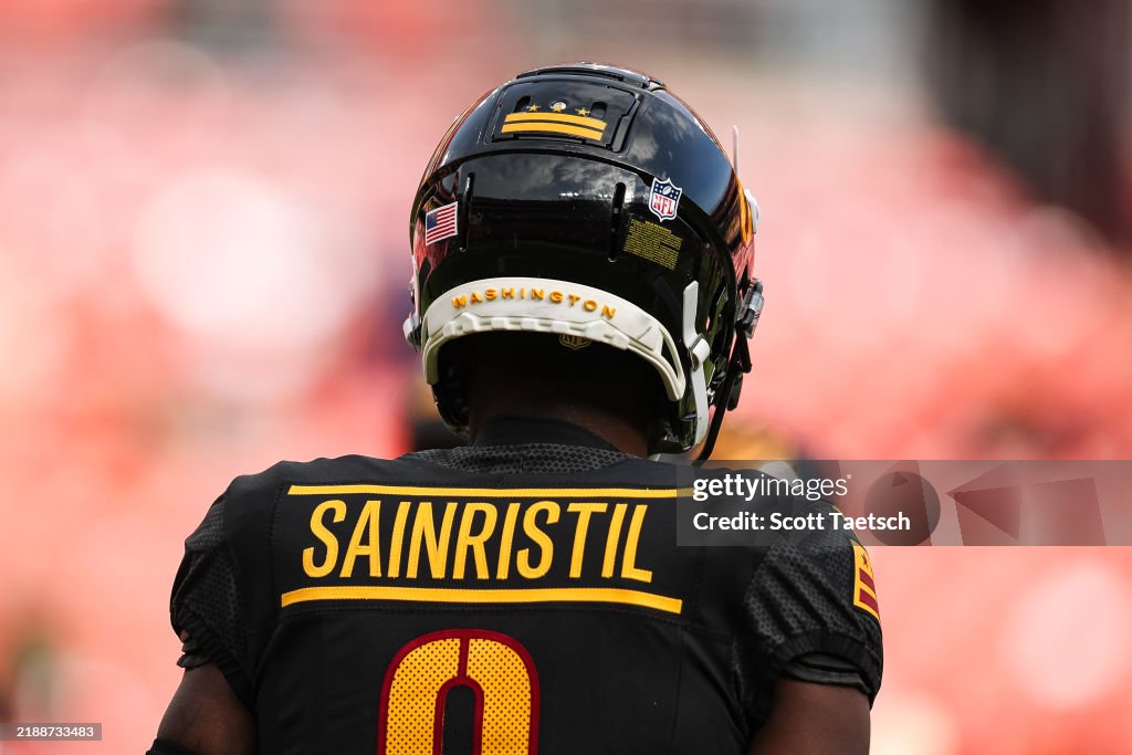 Mike Commanders Mike Sainristil of the Washington Commanders looks on before the game ...