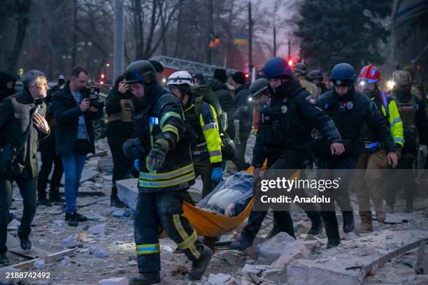 Emergency services work to rescue civilians trapped under the rubble of a destroyed building after Russian attack on Zaporizhzhia, Ukraine on...