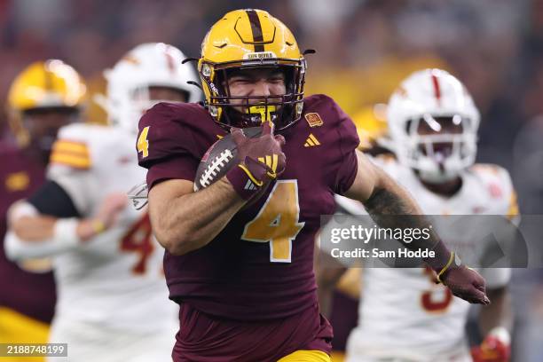 Cam Skattebo of the Arizona State Sun Devils carries the ball against the Iowa State Cyclones during the second quarter of the Big 12 Championship...