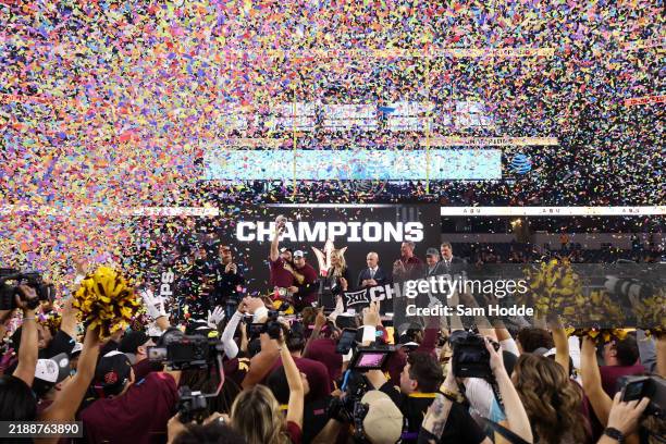 Cam Skattebo and head coach Kenny Dillingham of the Arizona State Sun Devils celebrate with the trophy after defeating the Iowa State Cyclones in the...