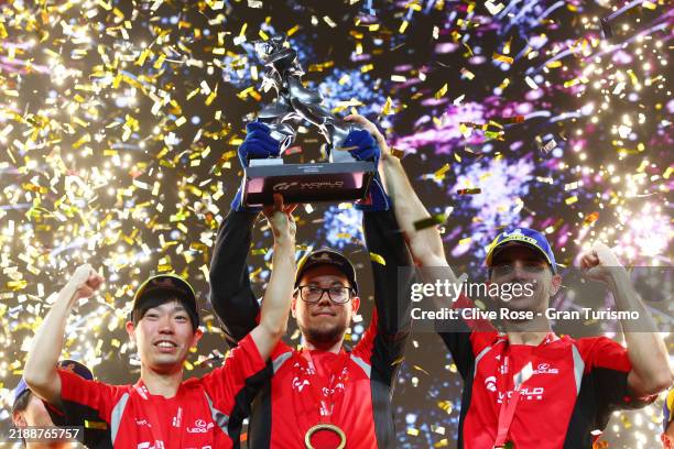 Manufacturers Cup champions Kanata Kawakami, Harald Walsen and Coque Lopez of Team Lexus lift the Manufacturers Cup of the Gran Turismo World Series...