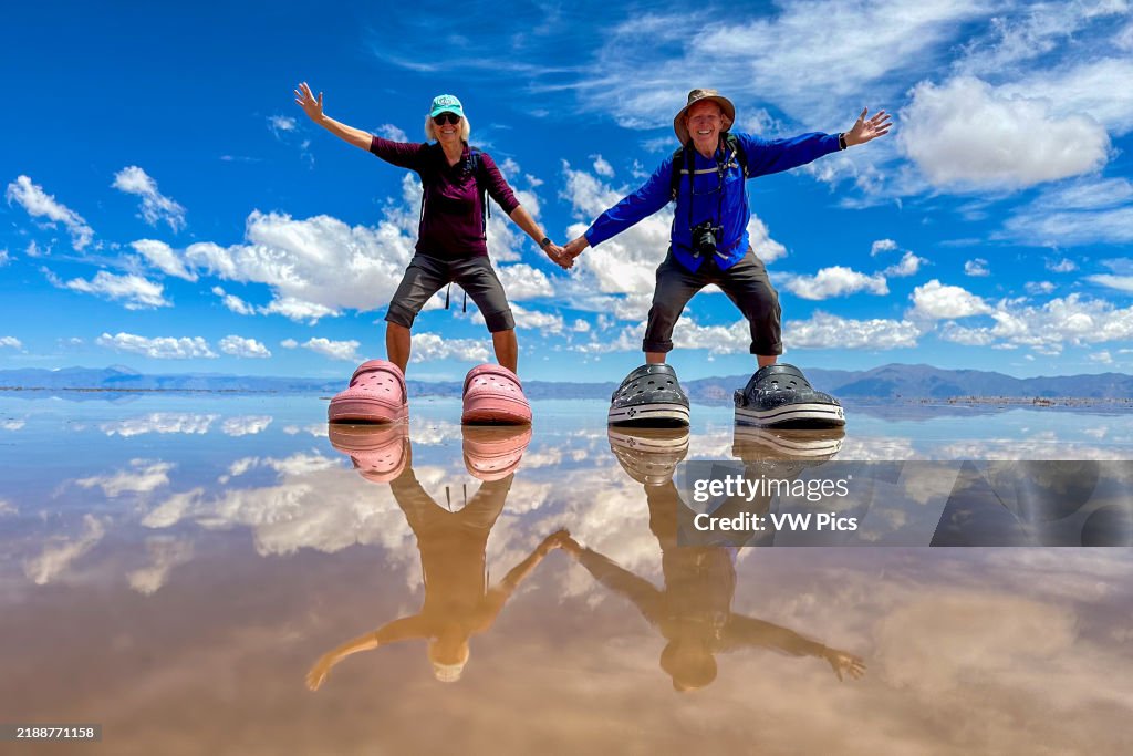 Tourists posing for humorous pictures on the salt flats of Salinas Grandes in northwest Argentina.. (photo by: Jon G. Fuller / VWPics/ Universal Images Group via Getty Images)