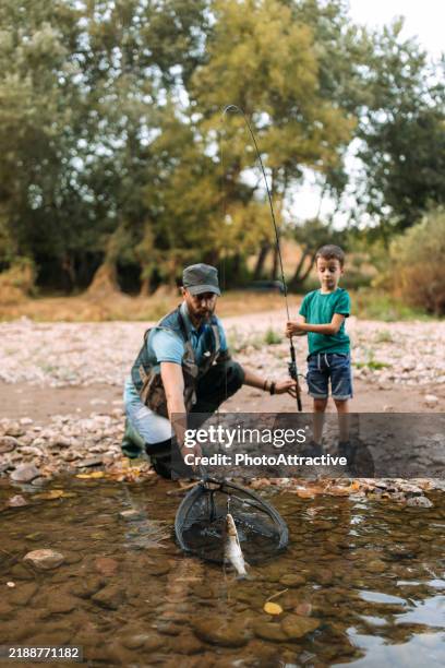 teamwork of a water and son on fishing - coarse fishing stock pictures, royalty-free photos & images
