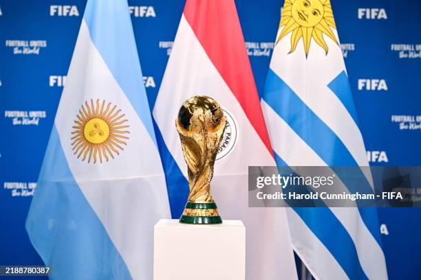 View of the FIFA World Cup Winner's Trophy with the flags of the hosts of the matches of the FIFA World Cup 2030 Centenary Celebration Uruguay,...