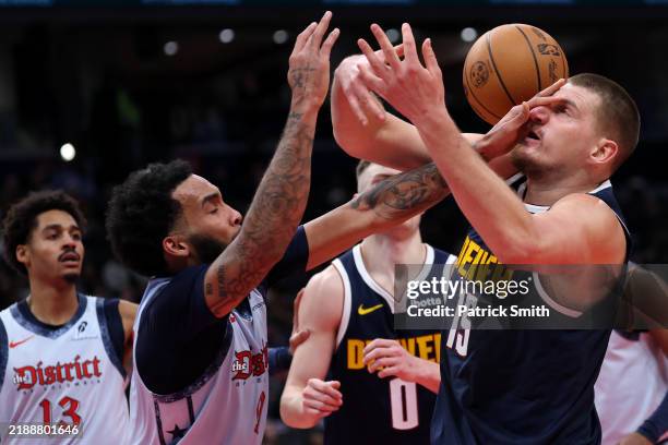 Nikola Jokic of the Denver Nuggets is fouled by Justin Champagnie of the Washington Wizards during the second half at Capital One Arena on December...