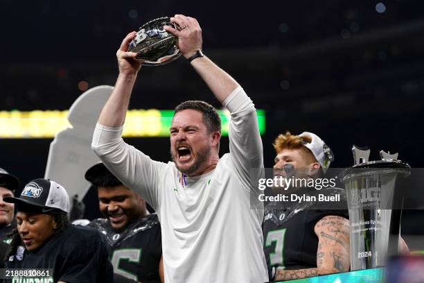Head coach Dan Lanning of the Oregon Ducks celebrates with the trophy after the team's 45-37 win against the Penn State Nittany Lions in the 2024 Big...