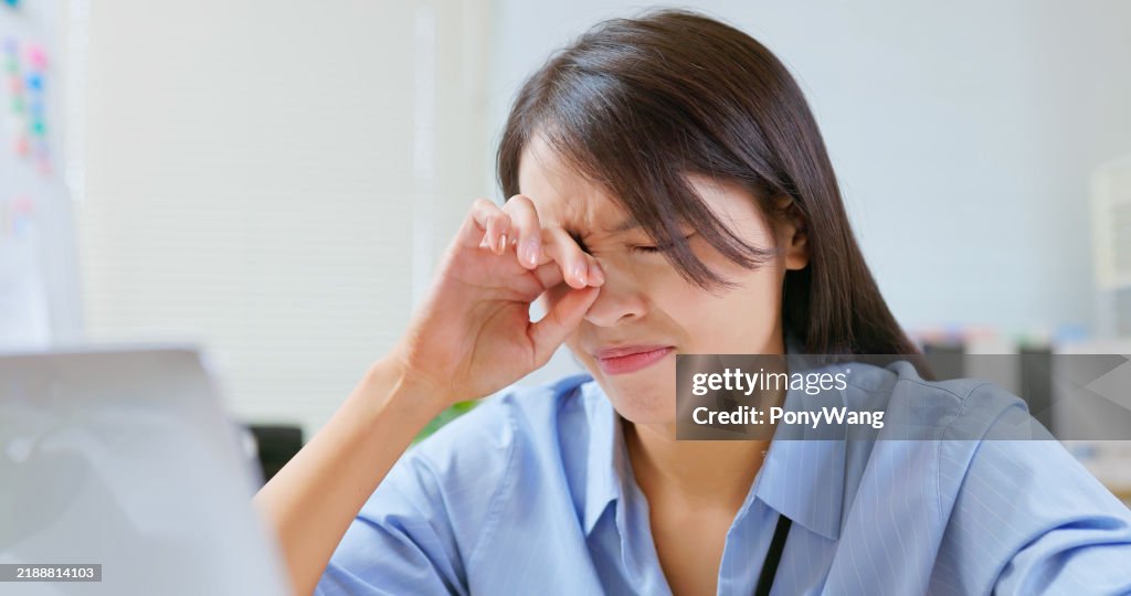 Woman eyes pain at work