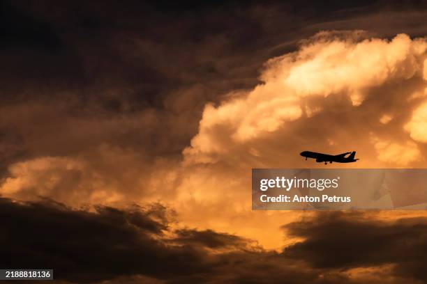 airplane at sunset against a background of thundercloud - clouds from aircraft point of view stock pictures, royalty-free photos & images