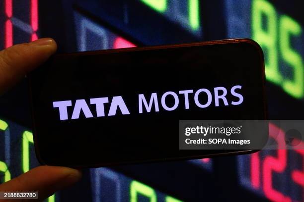 In this photo illustration, the Tata Motors company logo is seen displayed on a smartphone screen.