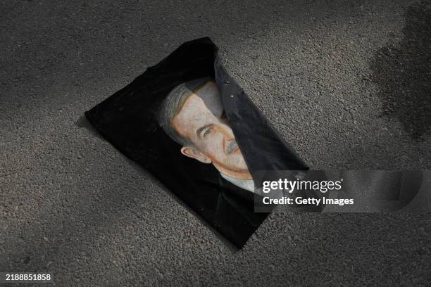 Portrait of Hafez al-Assad, father of Bashar al-Assad, is seen discarded, in Umayyad Square on December 8, 2024 in Damascus, Syria. Rebel forces in...