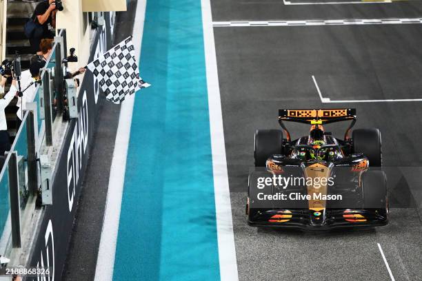 Race winner Lando Norris of Great Britain driving the McLaren MCL38 Mercedes takes the chequered flag during the F1 Grand Prix of Abu Dhabi at Yas...