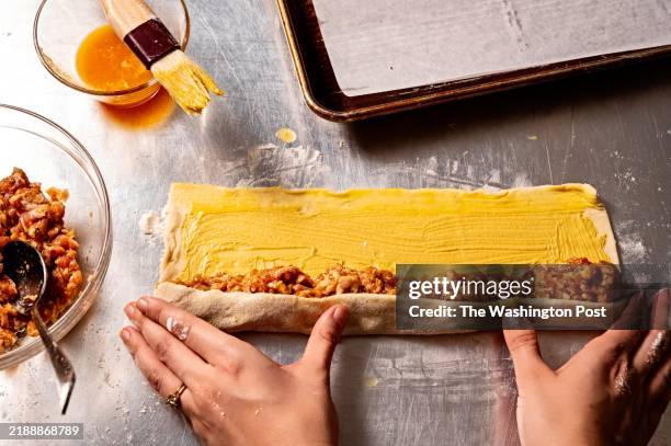 Using puff pastry to assemble Sausage Rolls In Puff Pastry photographed for Food in Washington, DC on December 9, 2024.