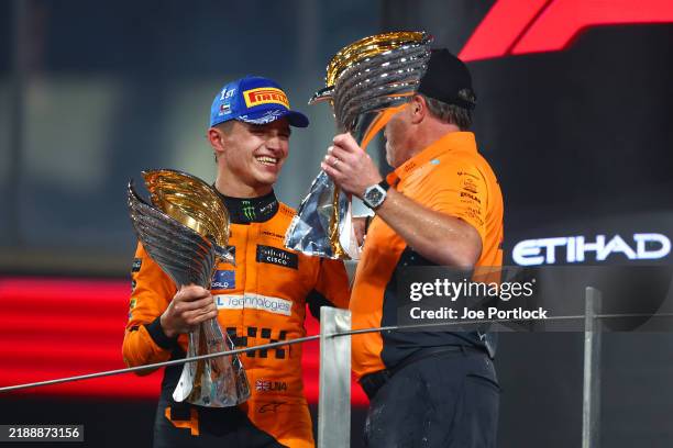 Race winner Lando Norris of Great Britain and McLaren and McLaren Chief Executive Officer Zak Brown celebrate on the podium after the McLaren team...