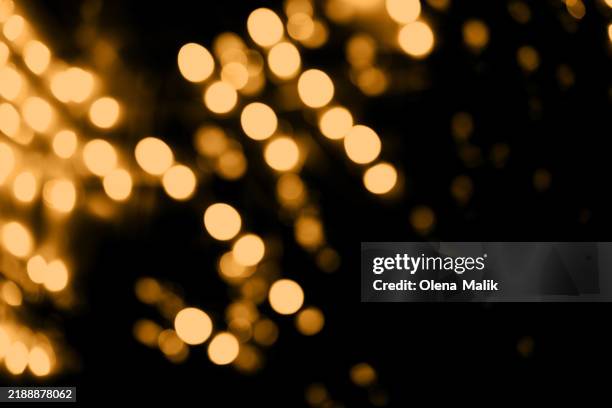 abstract golden bokeh lights creating warm festive atmosphere - low lighting stock pictures, royalty-free photos & images