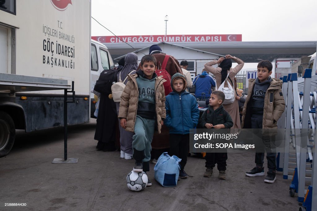 Syrian children are seen with a soccer ball at Cilvegozu...