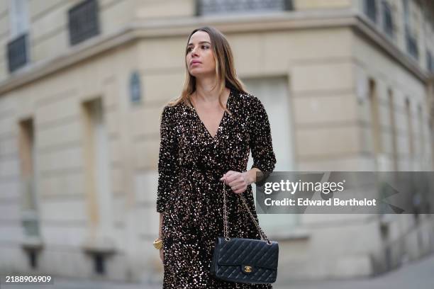 Maria Rosaria Rizzo wears a gold and black sequin dress, gold bracelet black leather Chanel bag, during a street style fashion photo session, on...