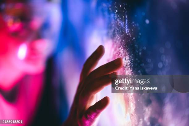 a person touching the digital interface. interaction with the unknown and cosmic exploration - big bang fotografías e imágenes de stock