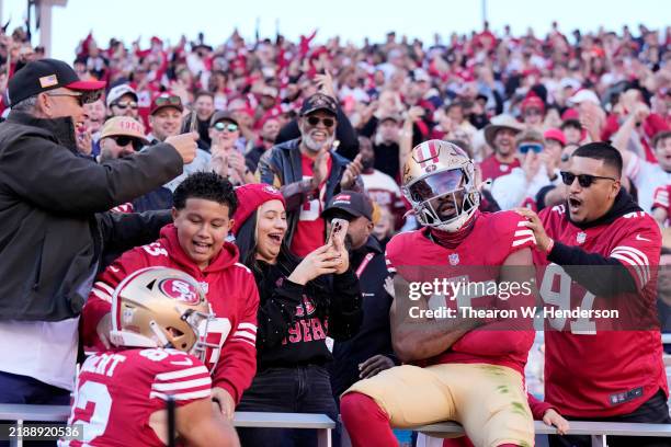 Jauan Jennings of the San Francisco 49ers celebrates a touchdown with fans in the stands during the first quarter of a game against the Chicago Bears...