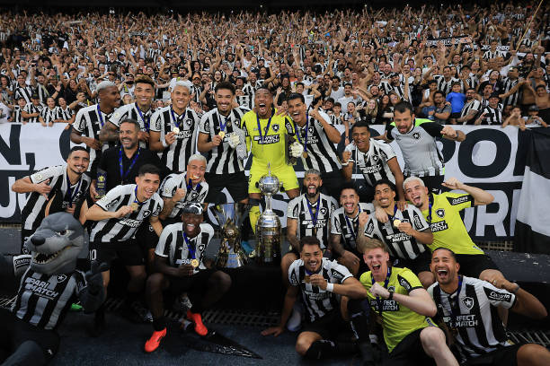 Players of Botafogo pose with the champions trophy after a match between Botafogo and Sao Paulo as part of Brasileirao 2024 at Estadio Olímpico...