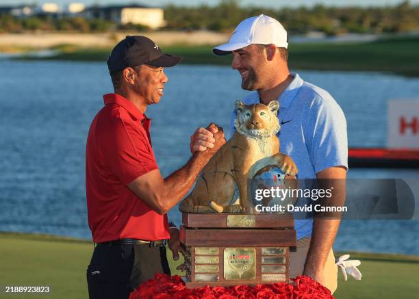 Scottie Scheffler of The United States is congratulated by the tournament host Tiger Woods of The United States at the presentation ceremony after...