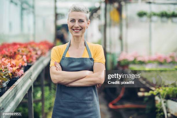 portrait of a smiling garden center manager - tuincentrum stockfoto's en -beelden