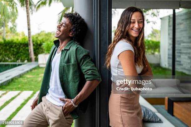 young friends sharing a happy moment together outdoors on a sunny day - tropical tree stock pictures, royalty-free photos & images