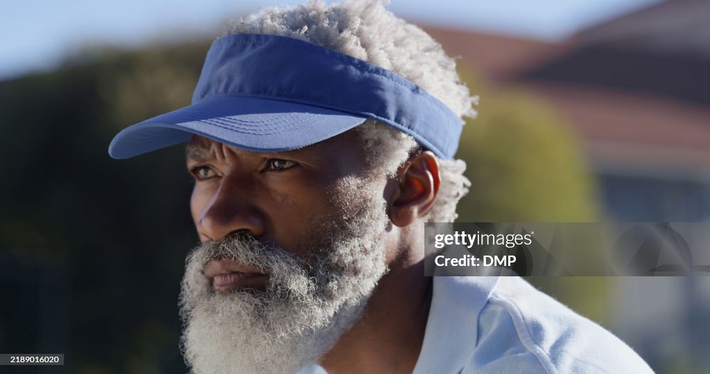 Tennis, court and face of mature black man with morning game, serious challenge or outdoor competition. Professional athlete, player or person with weekend hobby, fitness and health at sports club