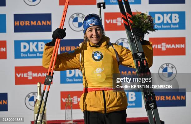 Germany's Franziska Preuss poses on the podium after winning the women's 7,5 km sprint event of the IBU World Cup on December 13, 2024 in Hochfilzen,...