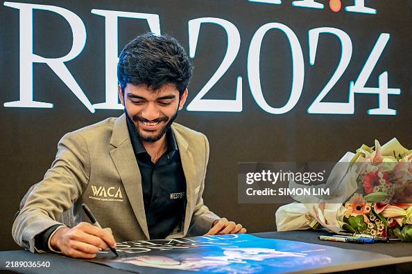 Gugesh World chess champion Gukesh Dommaraju signs an autograph during a ...