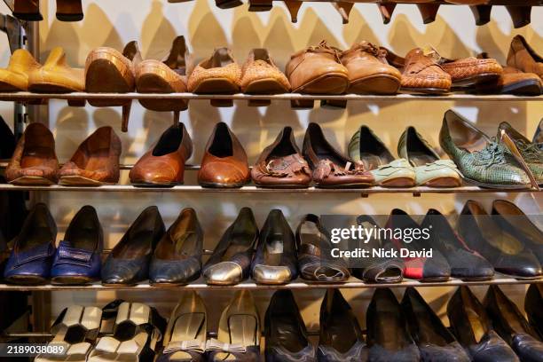 rows of shoes on racks in a vintage clothes store - fashion collection stock pictures, royalty-free photos & images