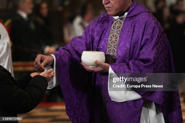 Priest offers Communion during the funeral mass for those who died in the floods caused by the DANA, at the Cathedral of Valencia, December 9 in...