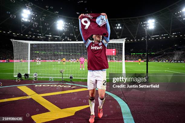Jarrod Bowen of West Ham United holds up a Michail Antonio shirt as he celebrates scoring his team's second goal during the Premier League match...