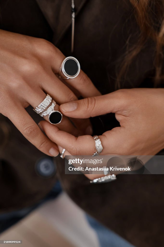 Close up of mysterious woman wearing luxurious silver jewelry.