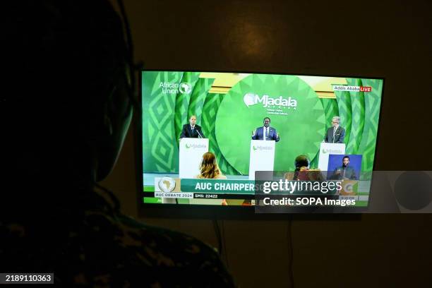 Person watches as former Kenyan Prime Minister Raila Odinga speaks during a live televised debate dubbed 'The Africa Leadership Debate' for the...