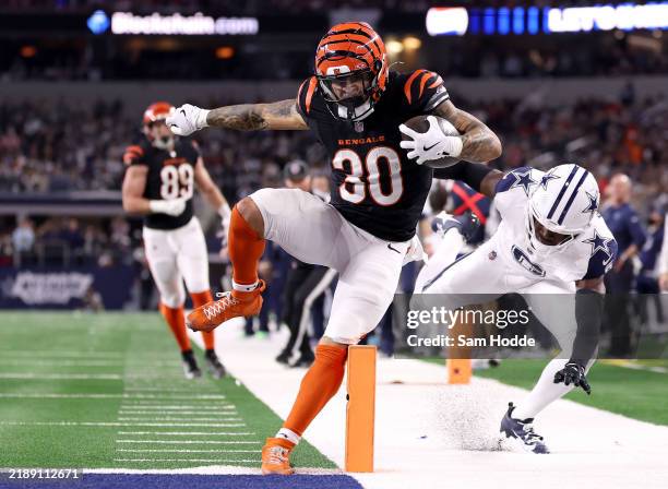 Chase Brown of the Cincinnati Bengals scores a 16 yard touchdown against Donovan Wilson of the Dallas Cowboys during the second quarter in the game...